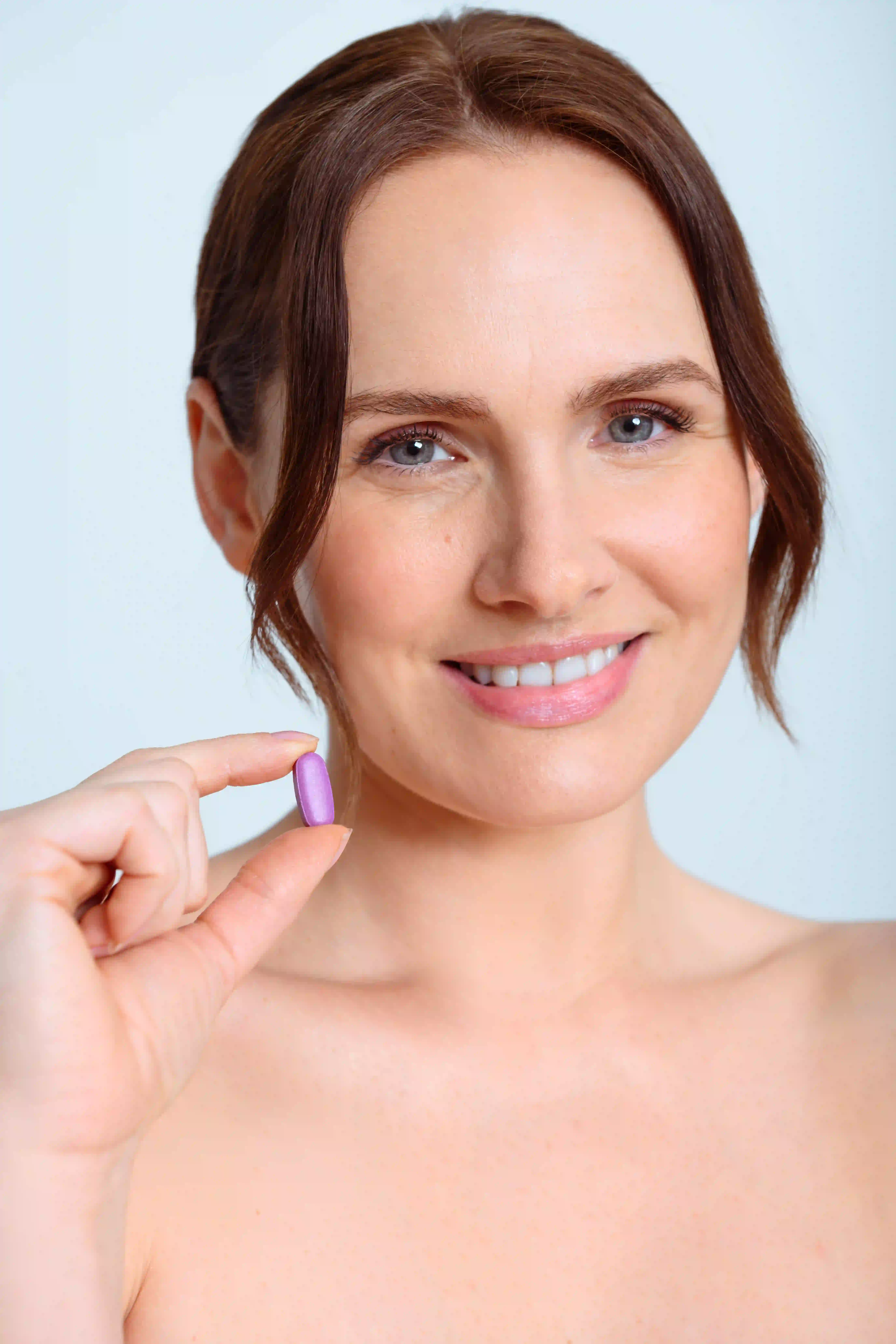 Model holding the night pill
